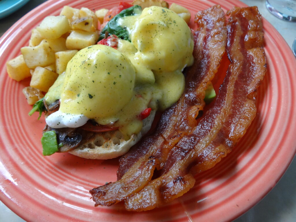 Eggs Benedict with bacon strips