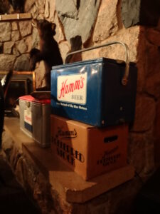 Hamm's cooler near the fireplace